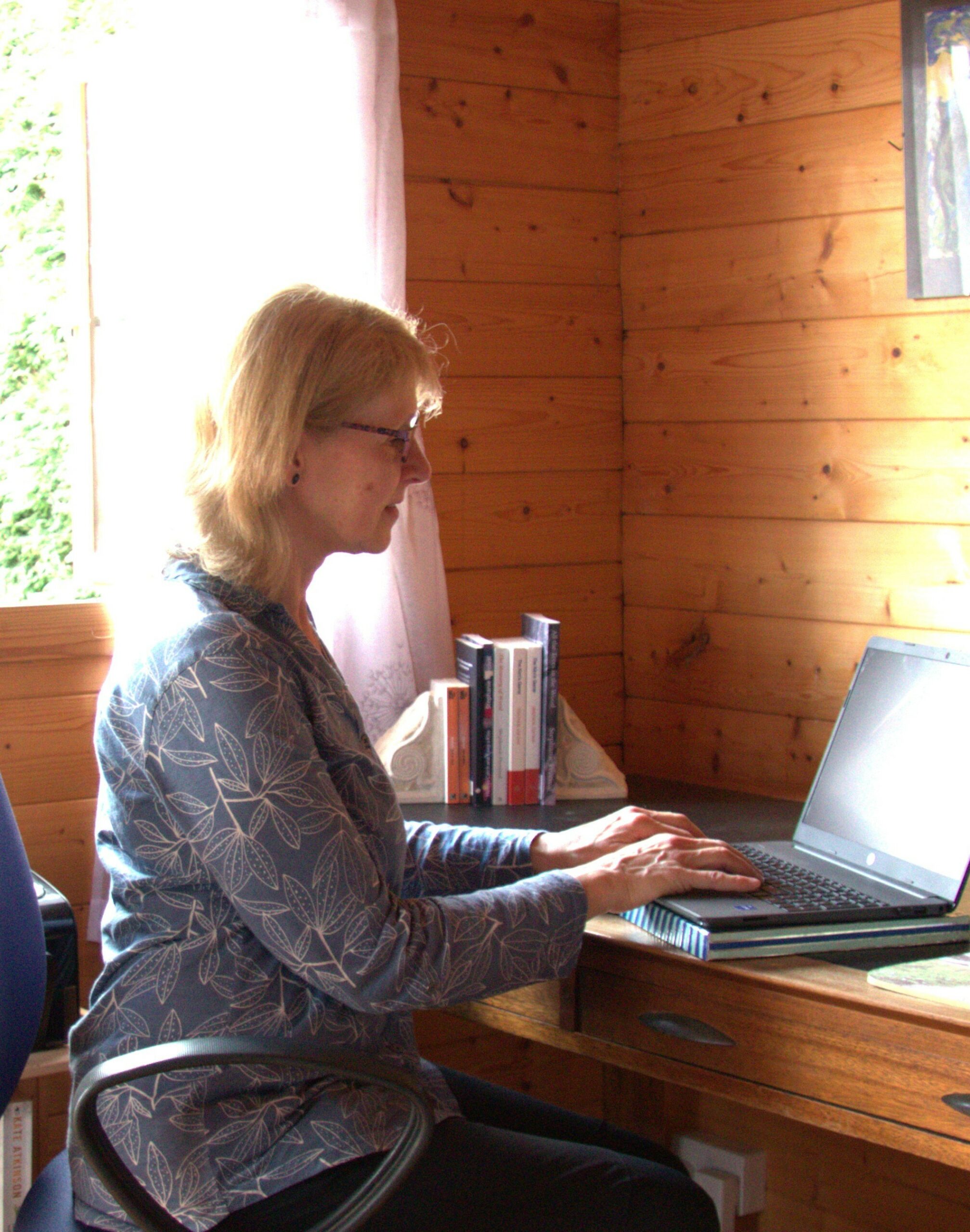 Stephanie Percival writing her captivating stories in her writing room